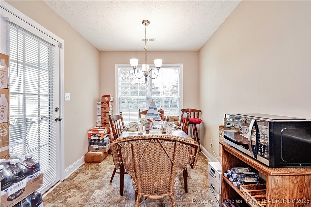 3453 Thrower Road Hope Mills, NC 28348 - Photo 6 of 24 a view of a dining room with furniture window and outside view