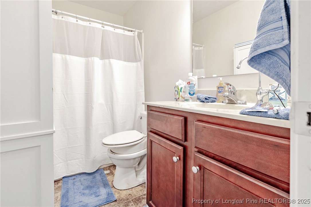 3453 Thrower Road Hope Mills, NC 28348 - Photo 10 of 24 a bathroom with a sink a toilet and shower