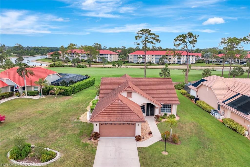 5859 Westbourgh Court Naples, FL 34112 - Photo 2 of 25 a aerial view of a house with a big yard