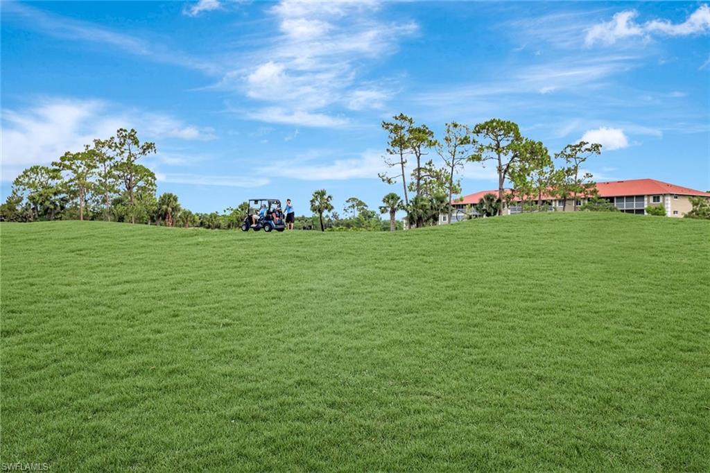 5859 Westbourgh Court Naples, FL 34112 - Photo 22 of 25 a view of a field with plants and bench
