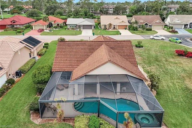 an aerial view of a house with a yard