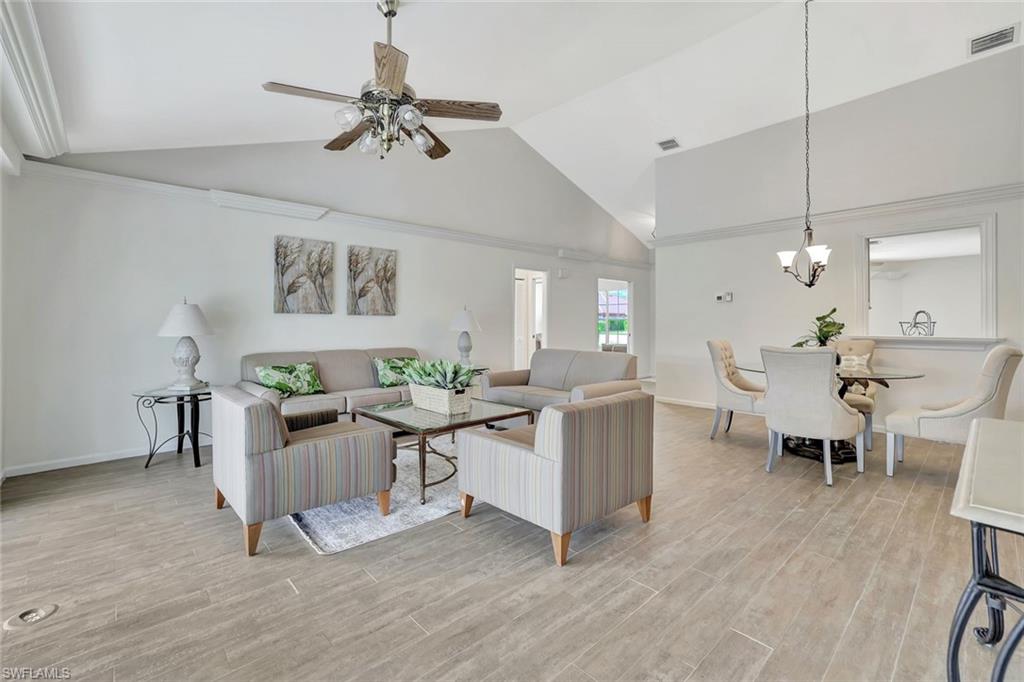 5859 Westbourgh Court Naples, FL 34112 - Photo 5 of 25 a view of a dining room with furniture and wooden floor