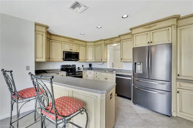 a kitchen with stainless steel appliances granite countertop a refrigerator stove top oven a sink and dishwasher