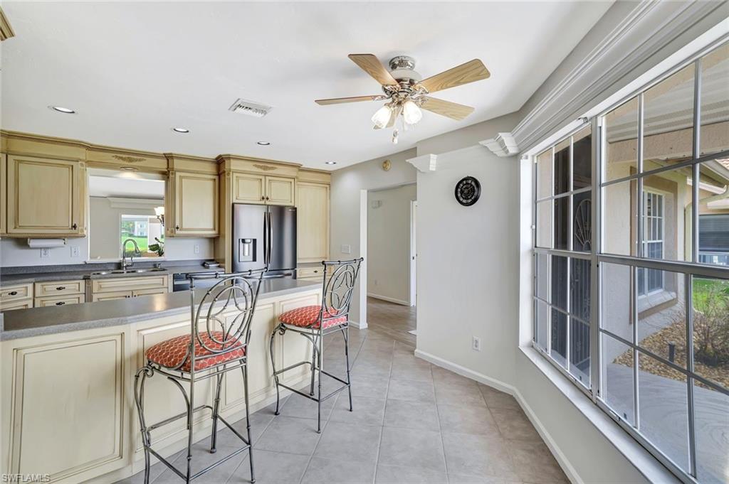 5859 Westbourgh Court Naples, FL 34112 - Photo 10 of 25 a view of a dining room with furniture window and wooden floor