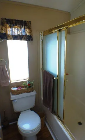 a white toilet sitting next to a bathroom sink