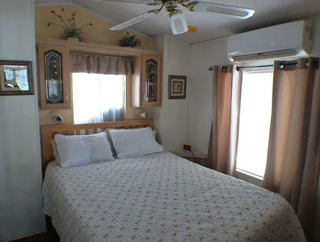 a bedroom with a large bed and a chandelier