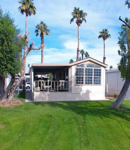a front view of a house with a yard table and chairs