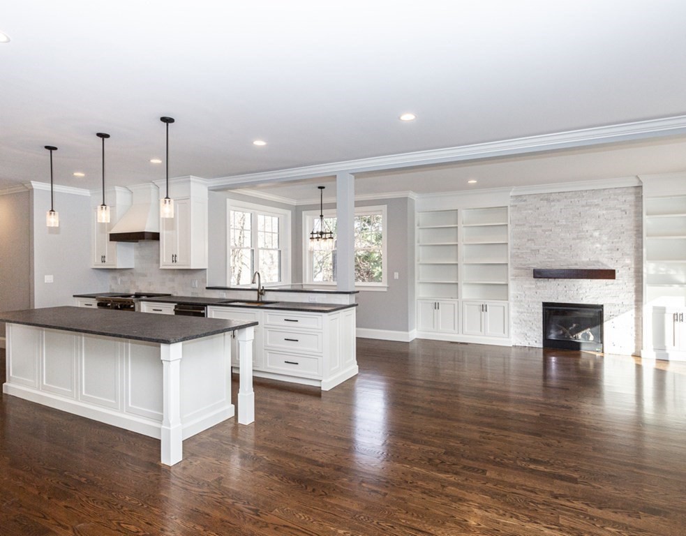 16 Jonathan Lane Bedford, MA 01730 - Photo 11 of 42 a kitchen with granite countertop a stove top oven a sink and a wooden floors