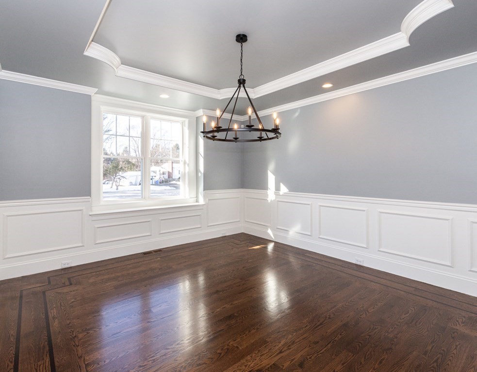 16 Jonathan Lane Bedford, MA 01730 - Photo 13 of 42 a view of a room with wooden floor chandelier and windows