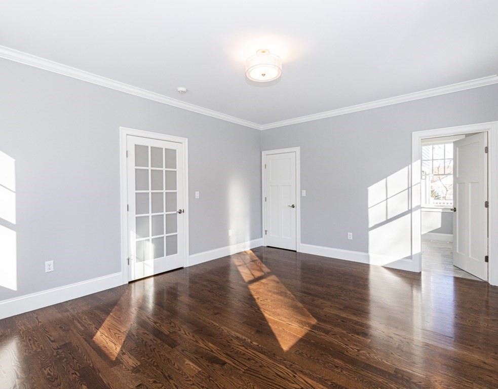16 Jonathan Lane Bedford, MA 01730 - Photo 15 of 42 an empty room with wooden floor and windows