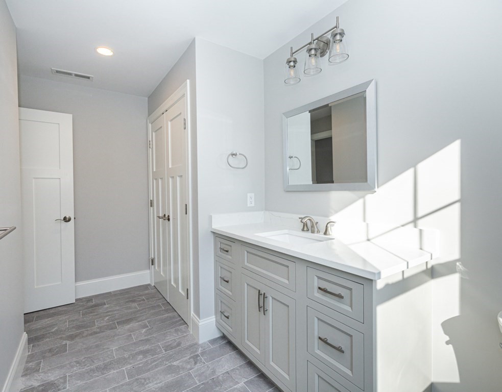 16 Jonathan Lane Bedford, MA 01730 - Photo 21 of 42 a bathroom with a sink and a mirror