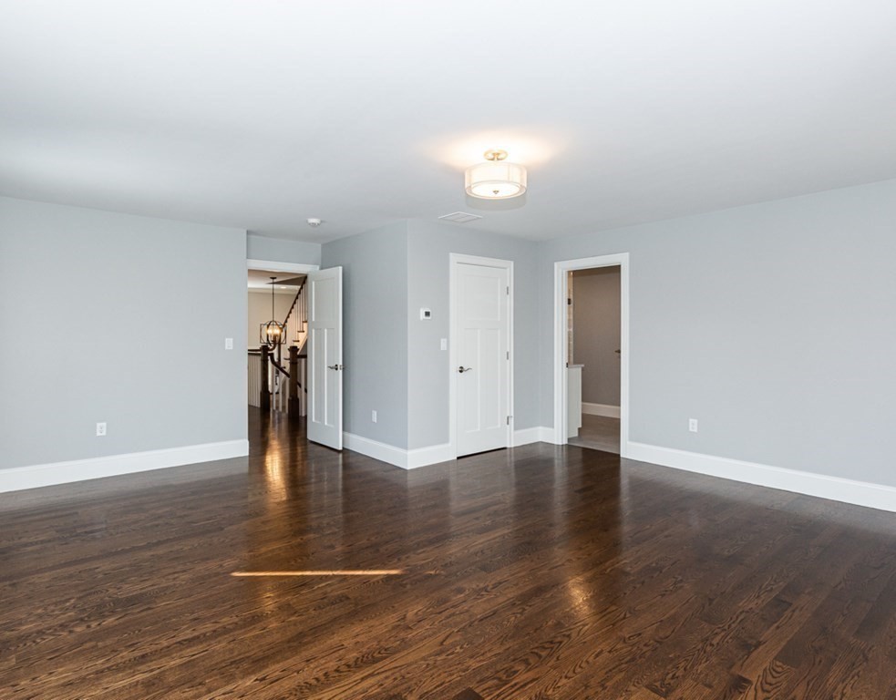 16 Jonathan Lane Bedford, MA 01730 - Photo 22 of 42 a view of an empty room with wooden floor