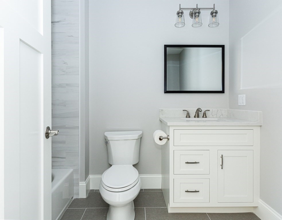 16 Jonathan Lane Bedford, MA 01730 - Photo 24 of 42 a bathroom with a toilet sink and mirror