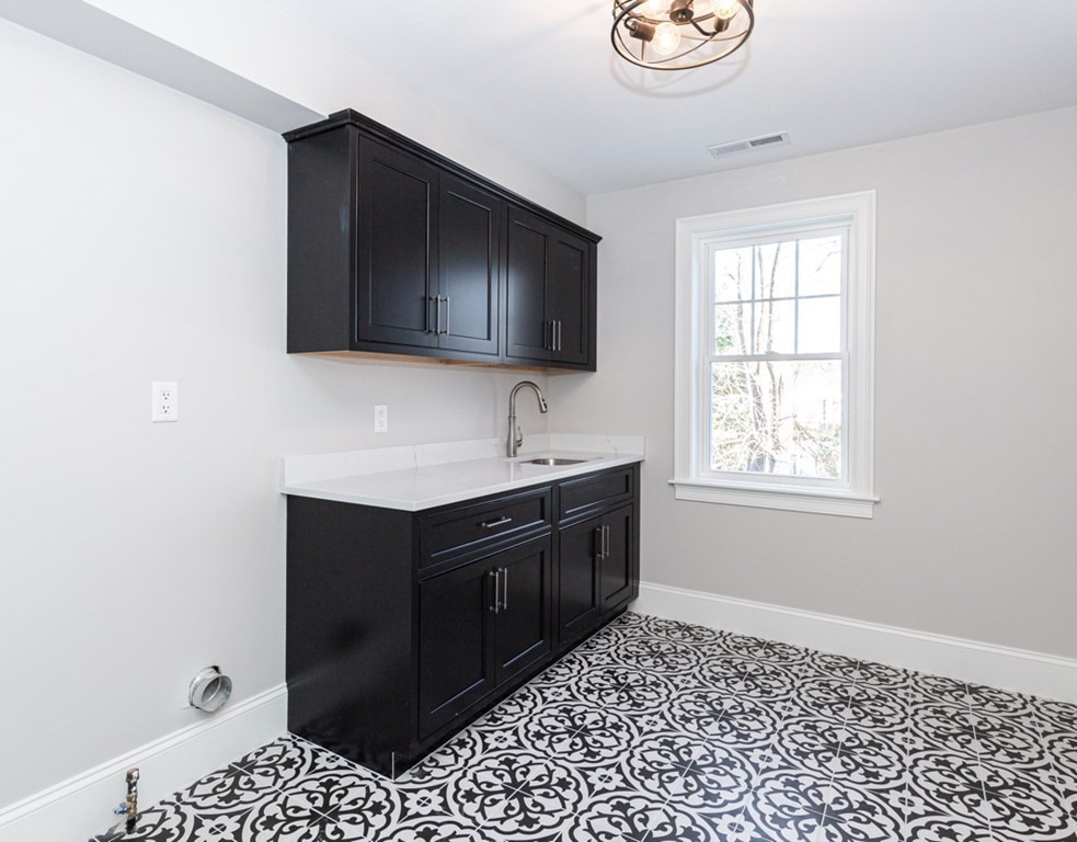 16 Jonathan Lane Bedford, MA 01730 - Photo 25 of 42 a kitchen with a sink cabinets and a window