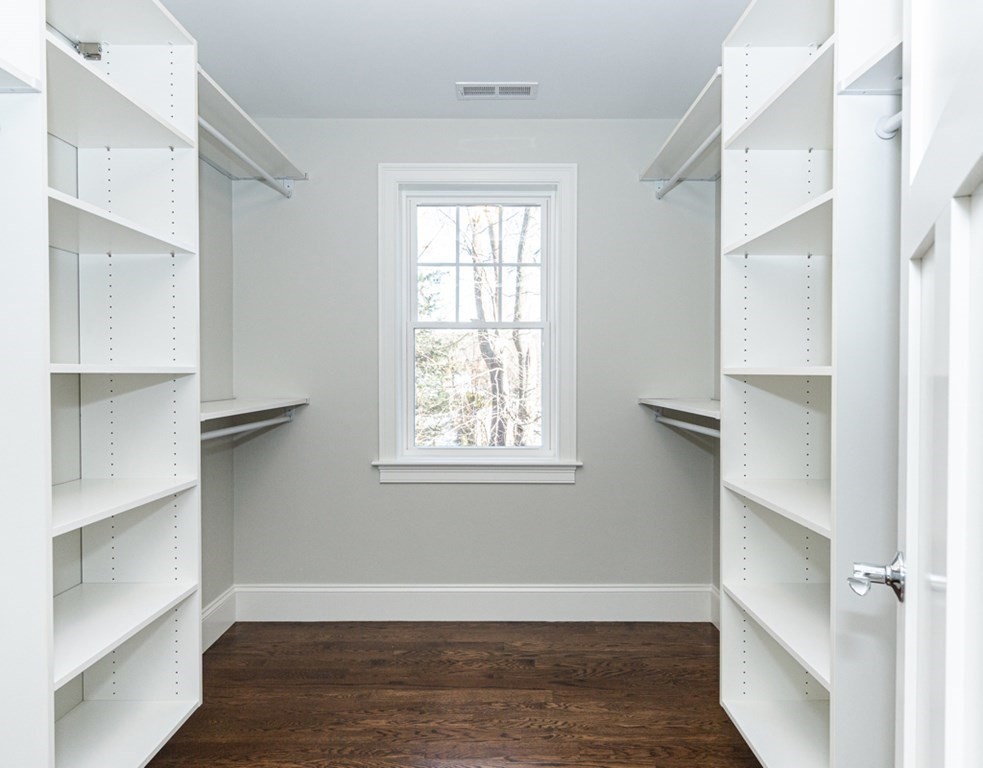 16 Jonathan Lane Bedford, MA 01730 - Photo 27 of 42 a view of an empty room with wooden floor and a window