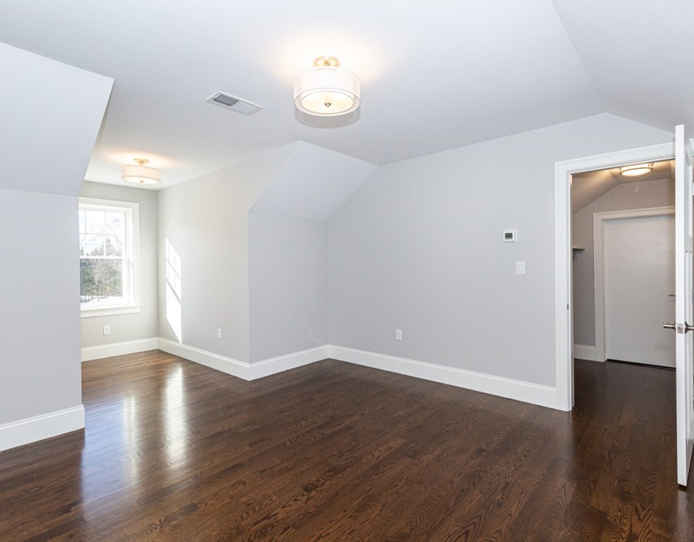 16 Jonathan Lane Bedford, MA 01730 - Photo 30 of 42 an empty room with wooden floor and windows