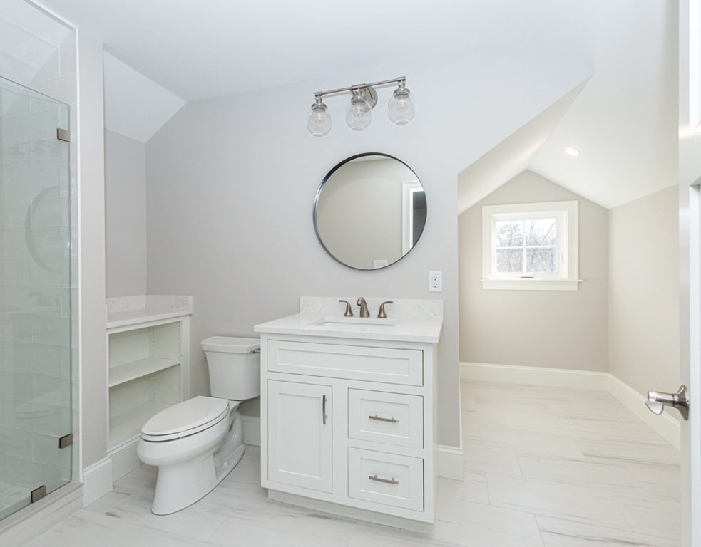 16 Jonathan Lane Bedford, MA 01730 - Photo 31 of 42 a bathroom with a toilet a sink a mirror and a window