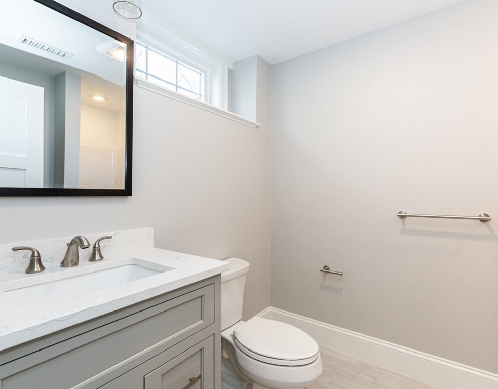 16 Jonathan Lane Bedford, MA 01730 - Photo 35 of 42 a bathroom with a sink a toilet and mirror