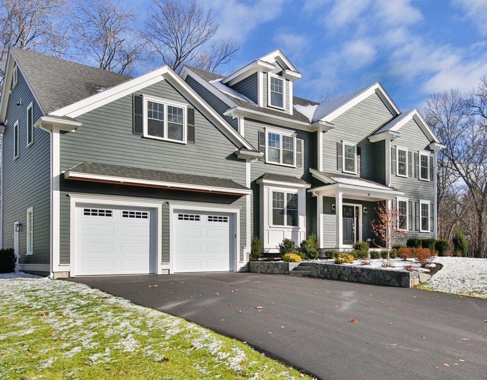 16 Jonathan Lane Bedford, MA 01730 - Photo 4 of 42 a front view of a house with a yard
