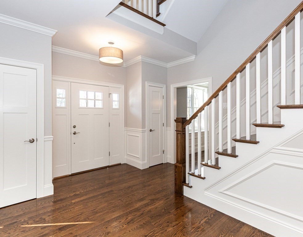 16 Jonathan Lane Bedford, MA 01730 - Photo 5 of 42 a view of an entryway with wooden floor and staircase