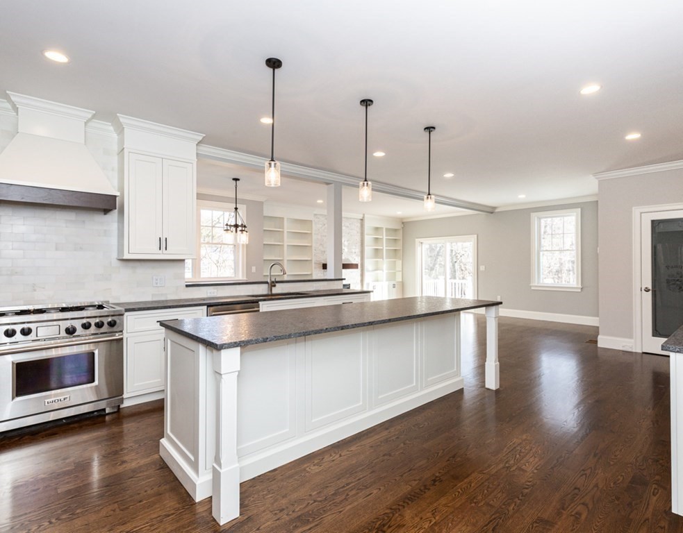 16 Jonathan Lane Bedford, MA 01730 - Photo 8 of 42 a kitchen with stainless steel appliances granite countertop a stove a sink and a wooden floors