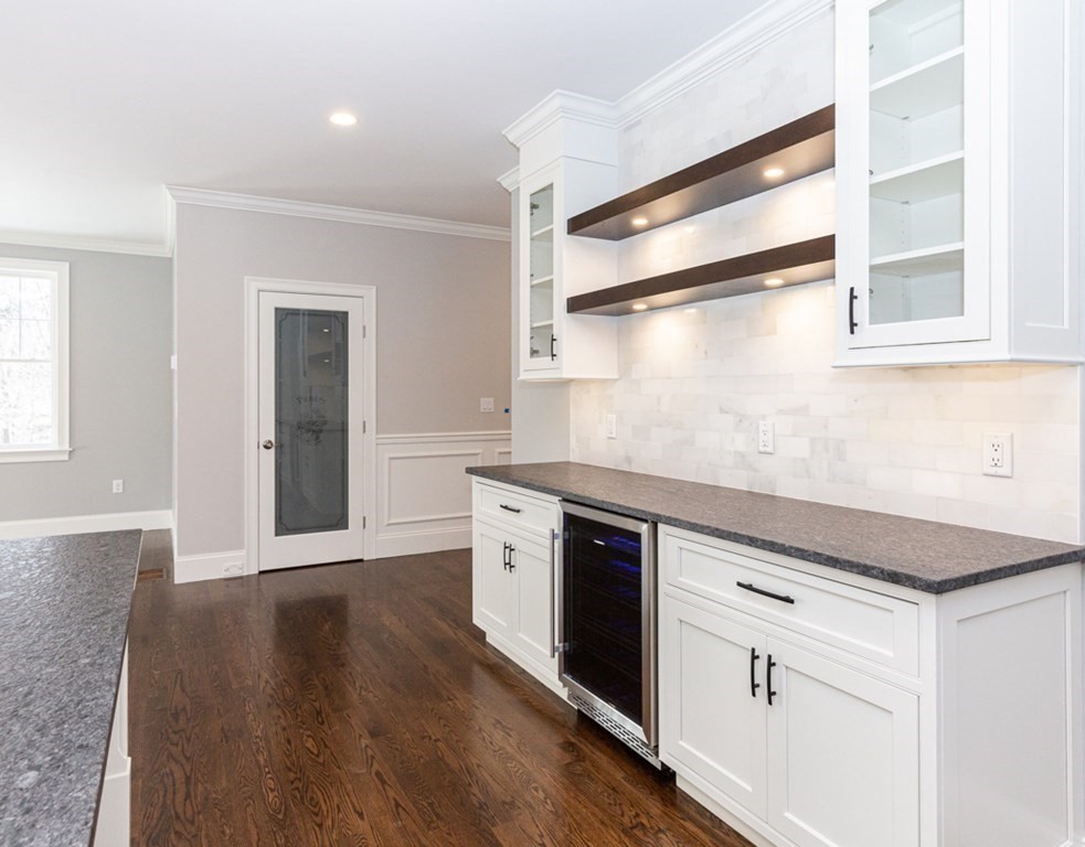 16 Jonathan Lane Bedford, MA 01730 - Photo 10 of 42 a kitchen with stainless steel appliances granite countertop a stove and a refrigerator