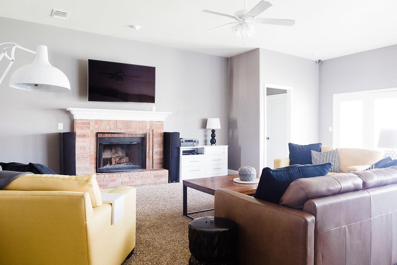 9108 Rochester Avenue Lubbock, TX 79424 - Photo 8 of 10 a living room with furniture a flat screen tv and a fireplace