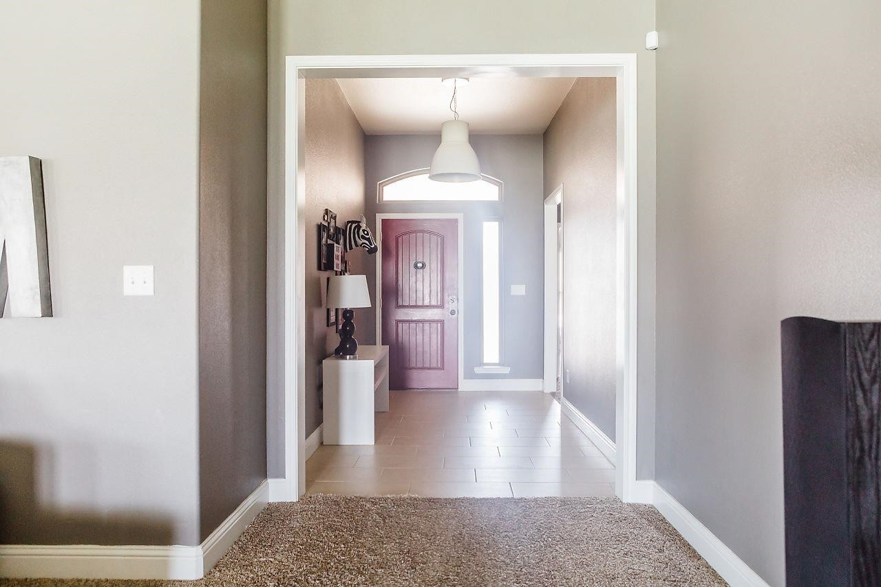 9108 Rochester Avenue Lubbock, TX 79424 - Photo 9 of 10 a view of a hallway with wooden floor and a living room