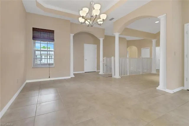 a view of a kitchen with a refrigerator and a stove top oven