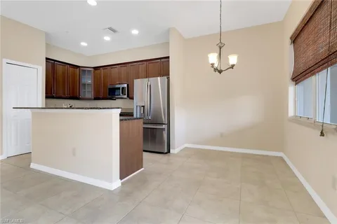 a kitchen with stainless steel appliances granite countertop a refrigerator and a stove top oven