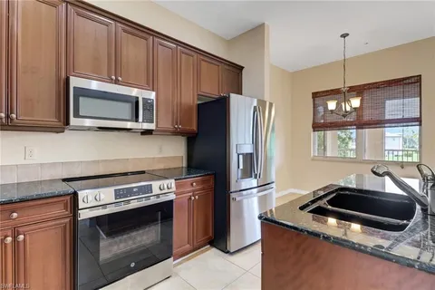 a kitchen with a sink and a stove top oven
