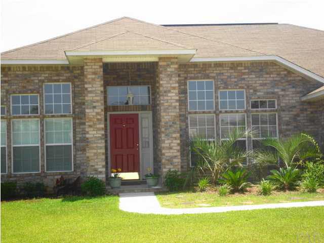 4951 Timber Ridge Drive Pace, FL 32571 - Photo 2 of 24 Take a look at the Landscaping and the attractive red door.