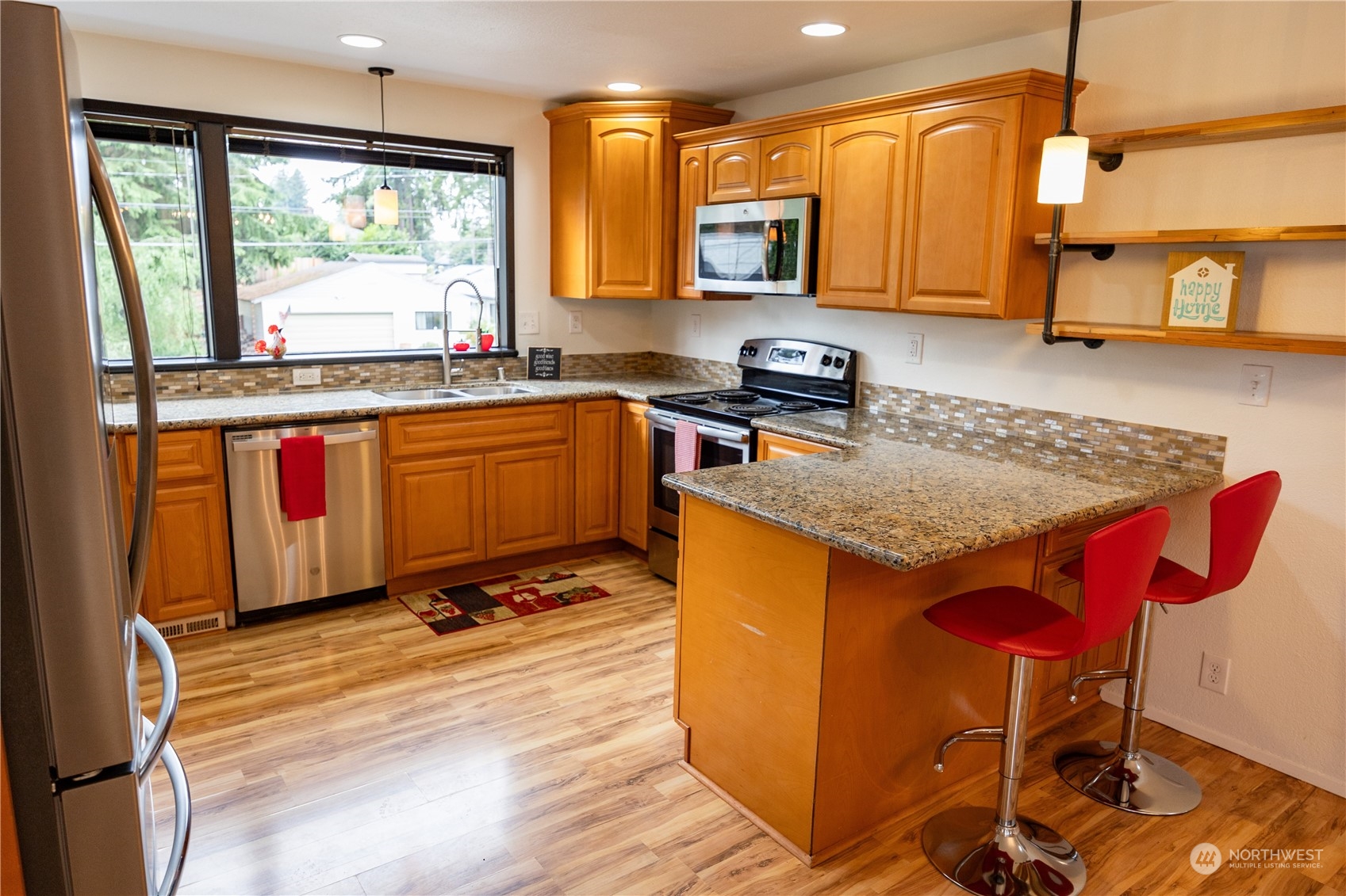 129 Del Monte Avenue Fircrest, WA 98466 - Photo 12 of 38 a kitchen with stainless steel appliances granite countertop a stove a sink and a microwave