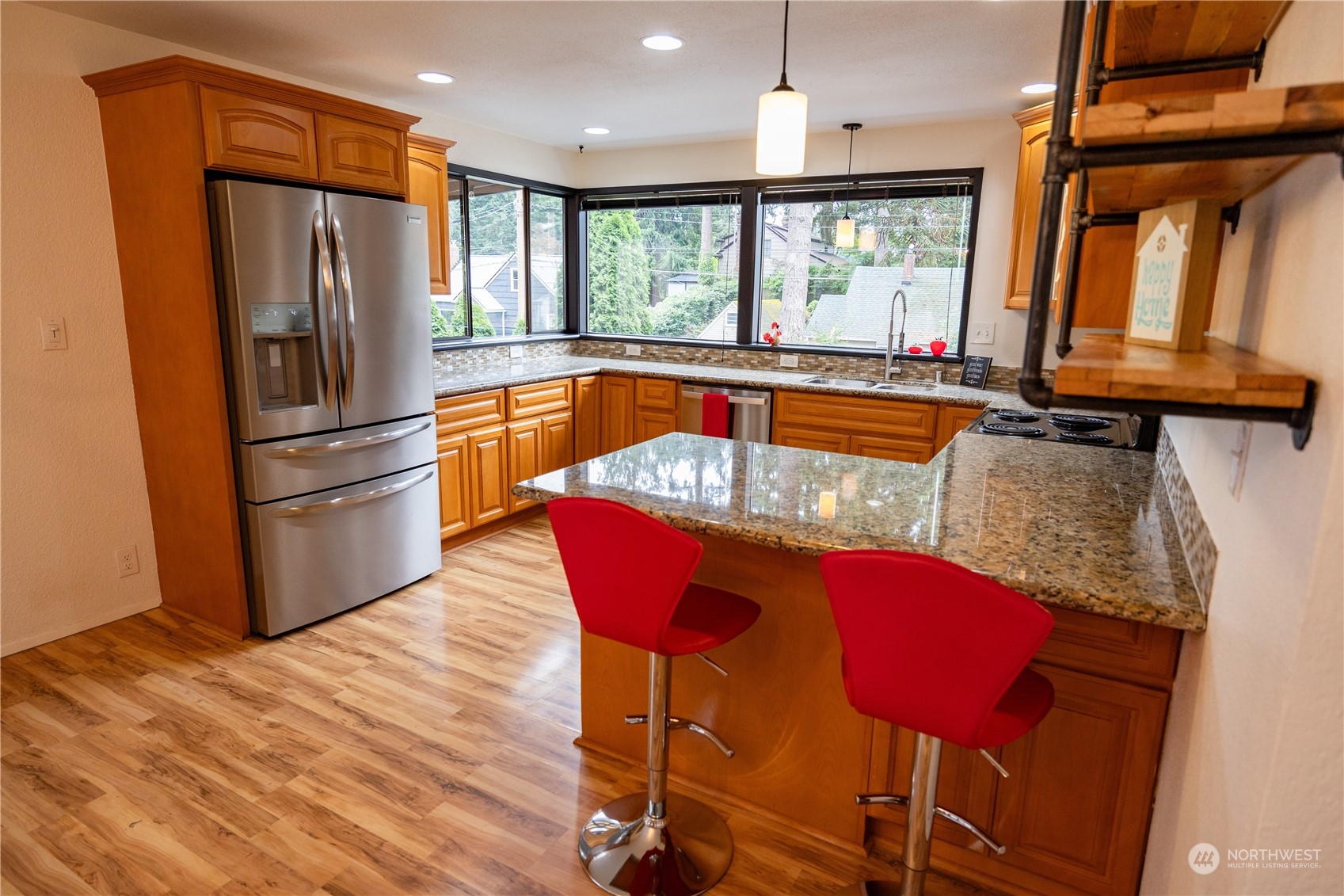 129 Del Monte Avenue Fircrest, WA 98466 - Photo 13 of 38 a kitchen with stainless steel appliances granite countertop a refrigerator a stove and a wooden floors