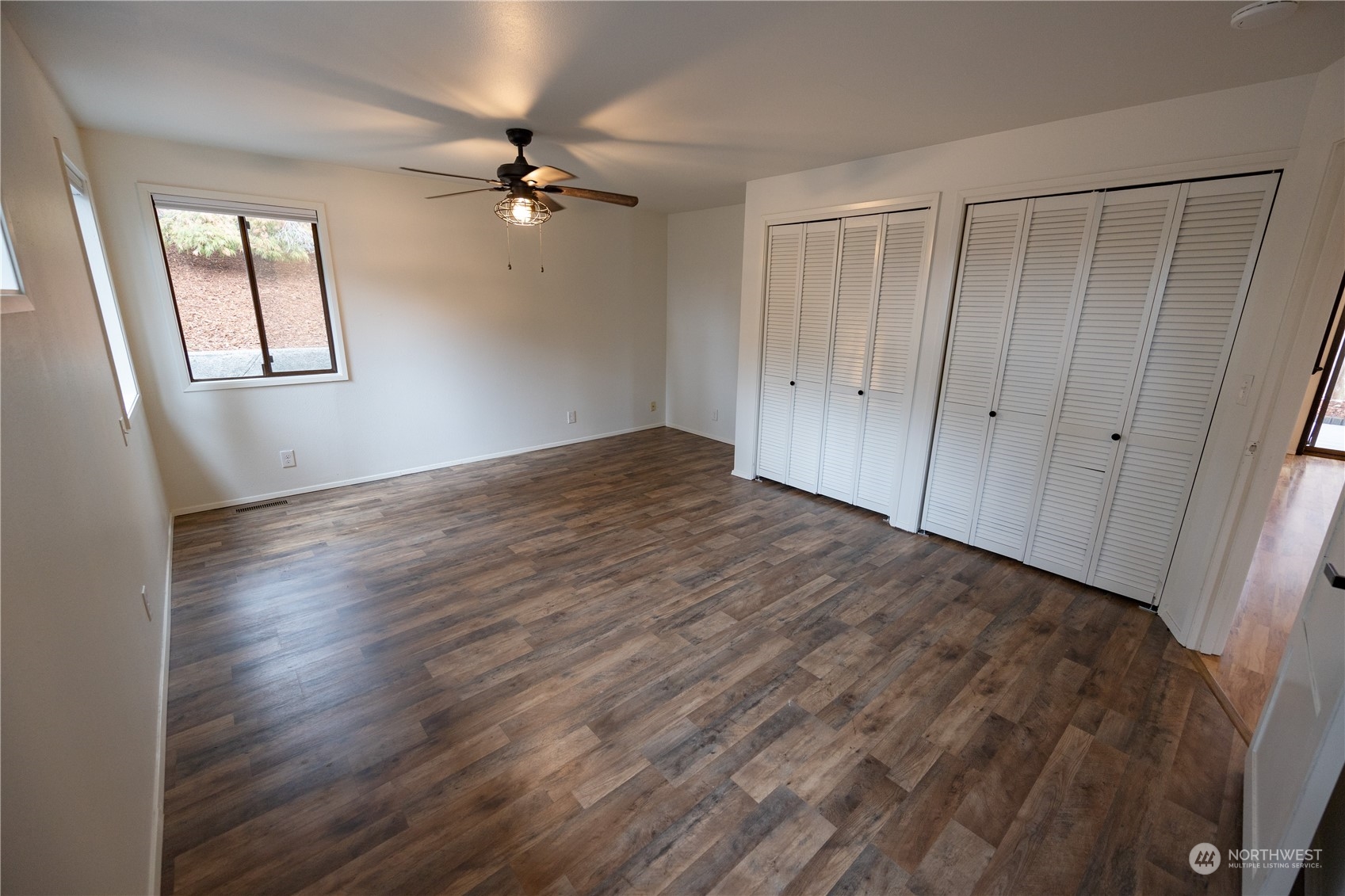 129 Del Monte Avenue Fircrest, WA 98466 - Photo 15 of 38 a view of an empty room with a window and wooden floor