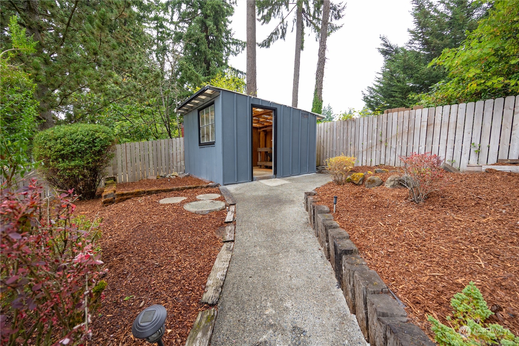 129 Del Monte Avenue Fircrest, WA 98466 - Photo 30 of 38 a backyard of a house with table and chairs