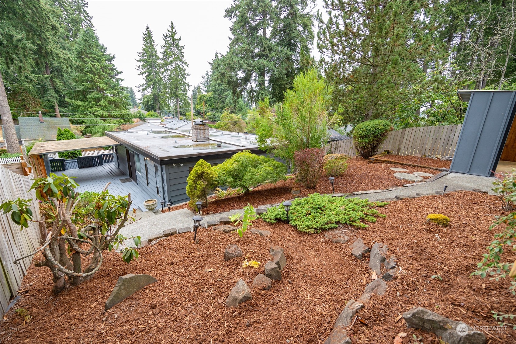 129 Del Monte Avenue Fircrest, WA 98466 - Photo 35 of 38 a view of a patio with table and chairs potted plants and large tree