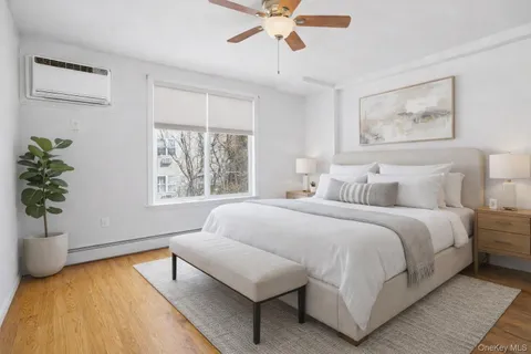 a bedroom with a large bed and a window