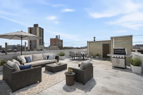 a view of a terrace with furniture and a fire pit