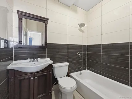 a bathroom with a sink toilet vanity and mirror