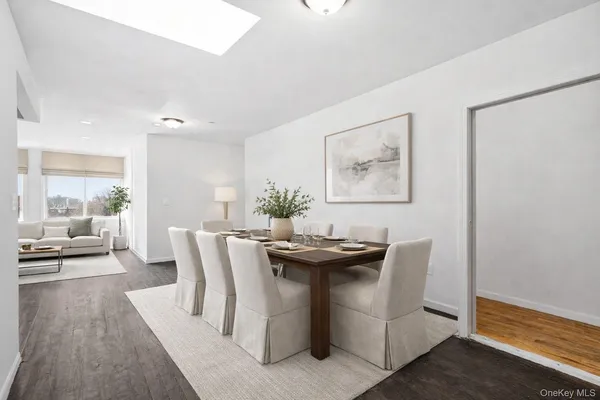 a dining room with furniture and wooden floor