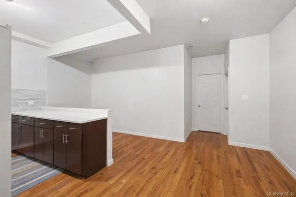 a kitchen with wooden floor and cabinets