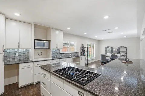 a kitchen with stainless steel appliances granite countertop a stove and a sink