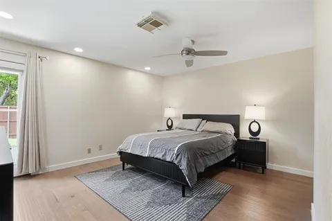 a bedroom with a bed and a ceiling fan