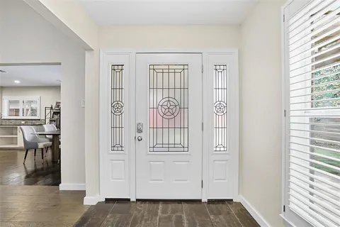 wooden floor with windows and closet in a room