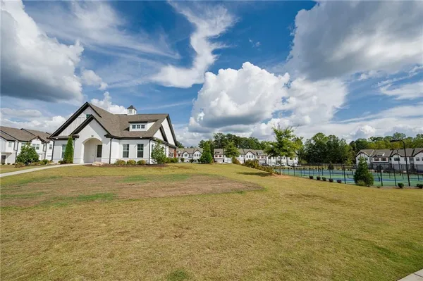 a front view of a house with a big yard