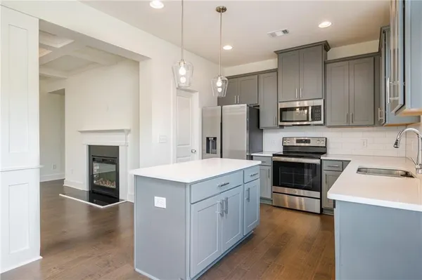 a kitchen with a sink stainless steel appliances and cabinets