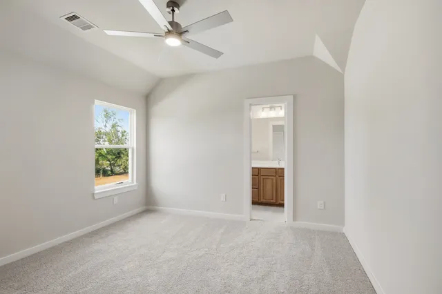 a bathroom with a sink toilet vanity and shower