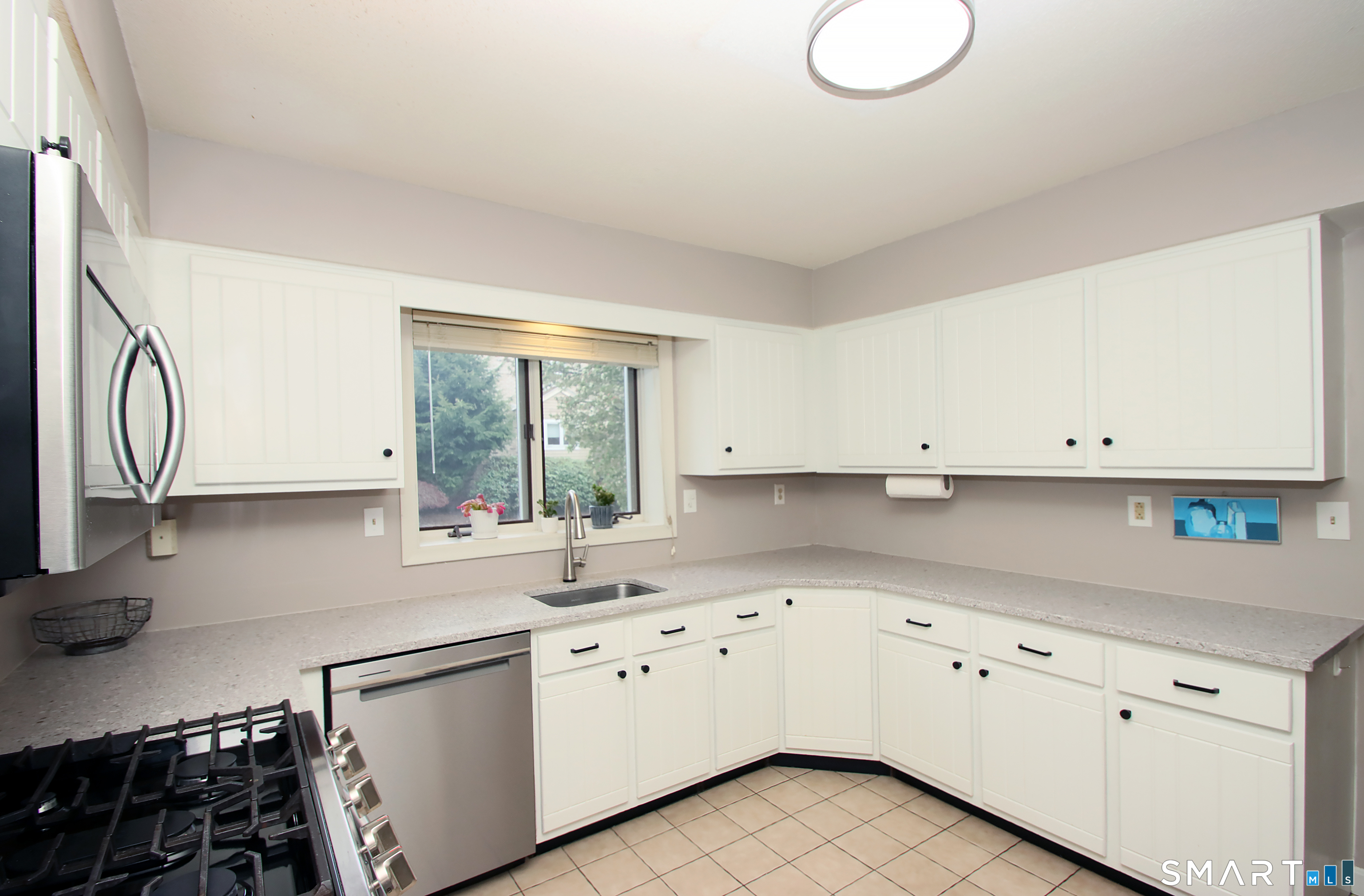182 Main Street, Unit A Manchester, CT 06042 - Photo 9 of 34 Updated Kitchen with white cabinets, Quartz Countertops, Stainless Steel Appliances.