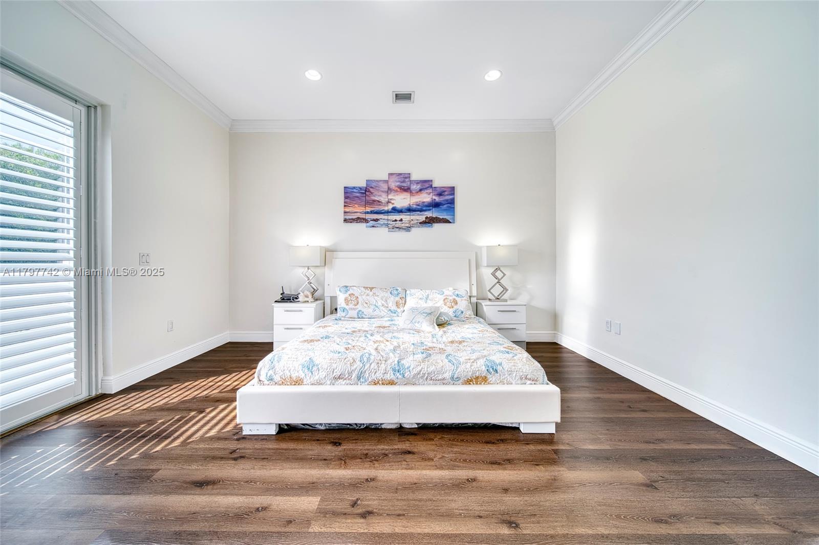 207 Southwest 11th Street Dania Beach, FL 33004 - Photo 17 of 37 a room with a bed and a painting on the wall